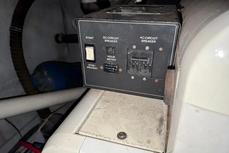 Slide: The Image of Control panel of a 1999 Carver 530 Voyager Pilothouse with circuit breakers and hour meter. - 48