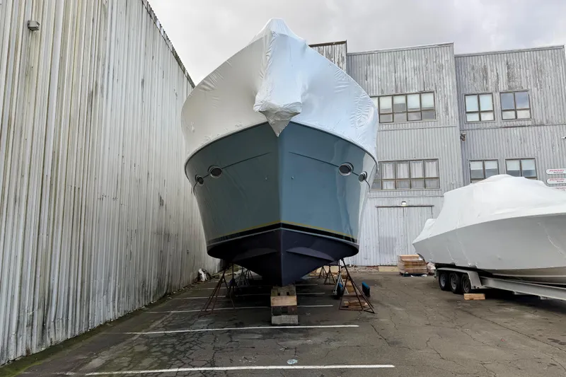 Slide: The Image of 1999 Carver 530 Voyager Pilothouse yacht covered and stored outdoors. - 6