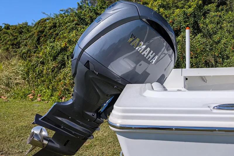 Slide: The Image of 2026 Parker 18SE Center Console with Yamaha outboard motor, parked on grass. - 14