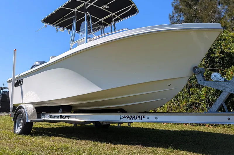 Slide: The Image of 2026 Parker 18SE Center Console boat on trailer, sunny day, grassy background. - 3