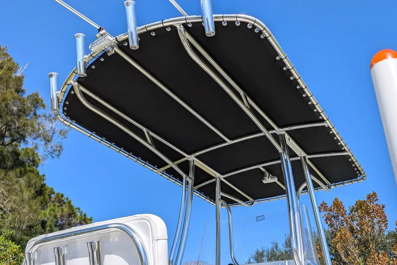 Slide: The Image of T-top of 2026 Parker 18SE Center Console boat against clear blue sky. - 5
