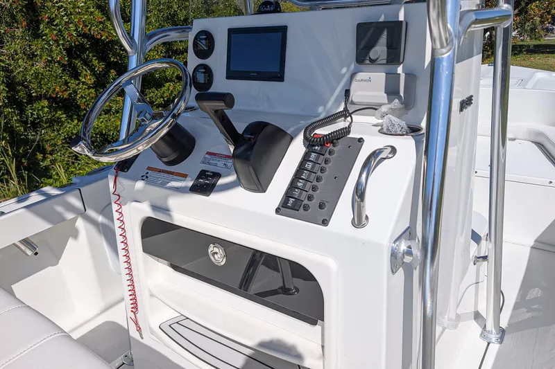 Slide: The Image of 2026 Parker 18SE Center Console boat dashboard with steering wheel and controls. - 6