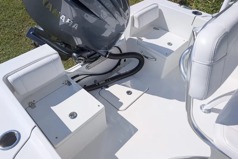 Slide: The Image of 2026 Parker 18SE Center Console boat interior with Yamaha engine, featuring white seating and storage compartments. - 9