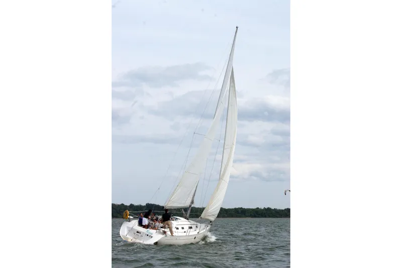 The Image of Sailing on a 1993 Beneteau First 310 yacht with full sails on a cloudy day. - 1