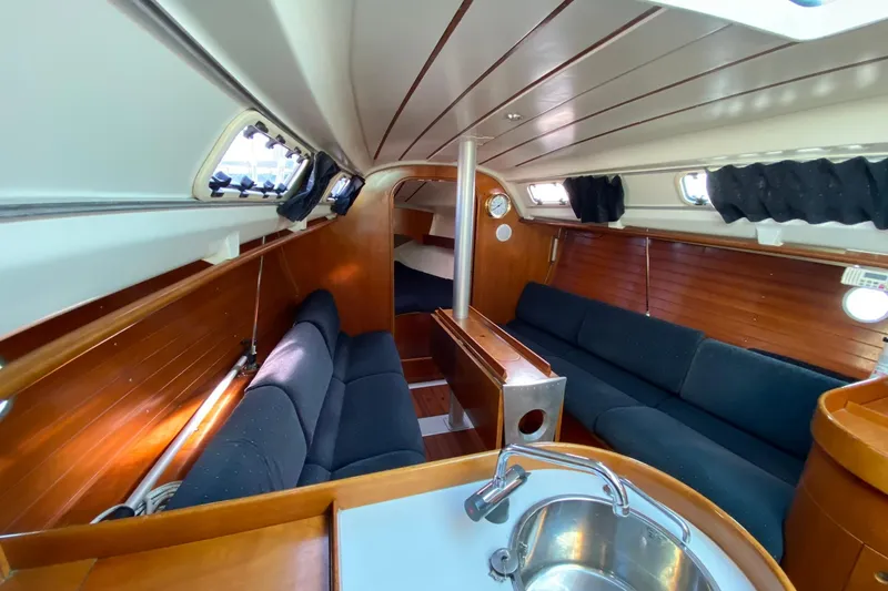 Slide: The Image of Interior of 1993 Beneteau First 310 sailboat with wood paneling and seating. - 10