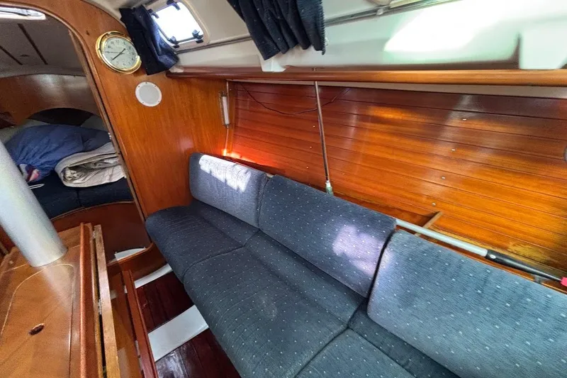 Slide: The Image of Interior of 1993 Beneteau First 310 sailboat with wooden paneling and blue upholstery. - 15