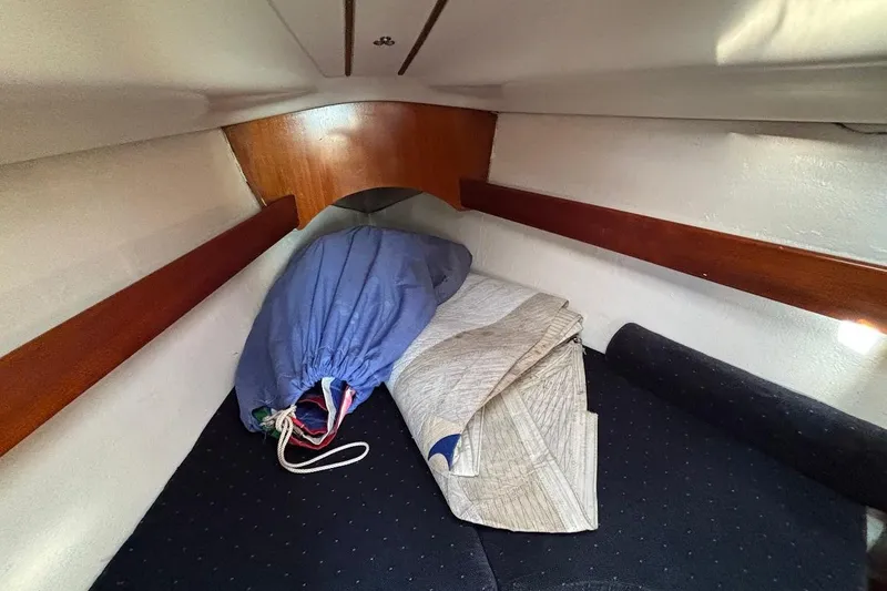Slide: The Image of Interior cabin of 1993 Beneteau First 310 sailboat with storage and cushions. - 16