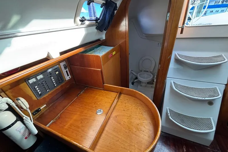 Slide: The Image of Interior of 1993 Beneteau First 310 sailboat with navigation station and compact bathroom. - 18