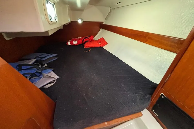 Slide: The Image of Cozy cabin interior of 1993 Beneteau First 310 sailboat with life jackets. - 19
