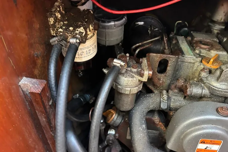 Slide: The Image of Engine compartment of a 1993 Beneteau First 310 sailboat, showing hoses and components. - 23