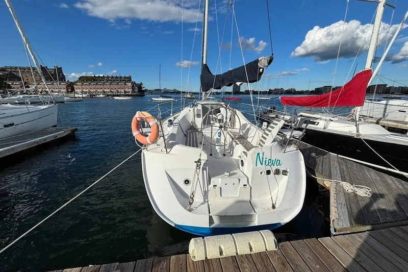 Slide: The Image of Beneteau First 310 sailboat docked at marina, clear sky, 1993 model. - 3