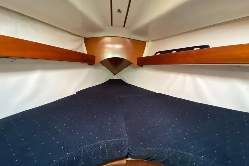 Slide: The Image of Cozy cabin interior of 1993 Beneteau First 310 sailboat with wooden shelves. - 9