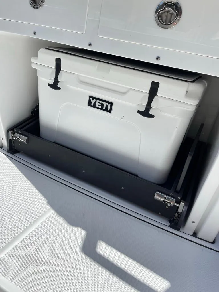 Slide: The Image of 2019 Blackfin 272 CC boat with Yeti cooler in storage compartment. - 12