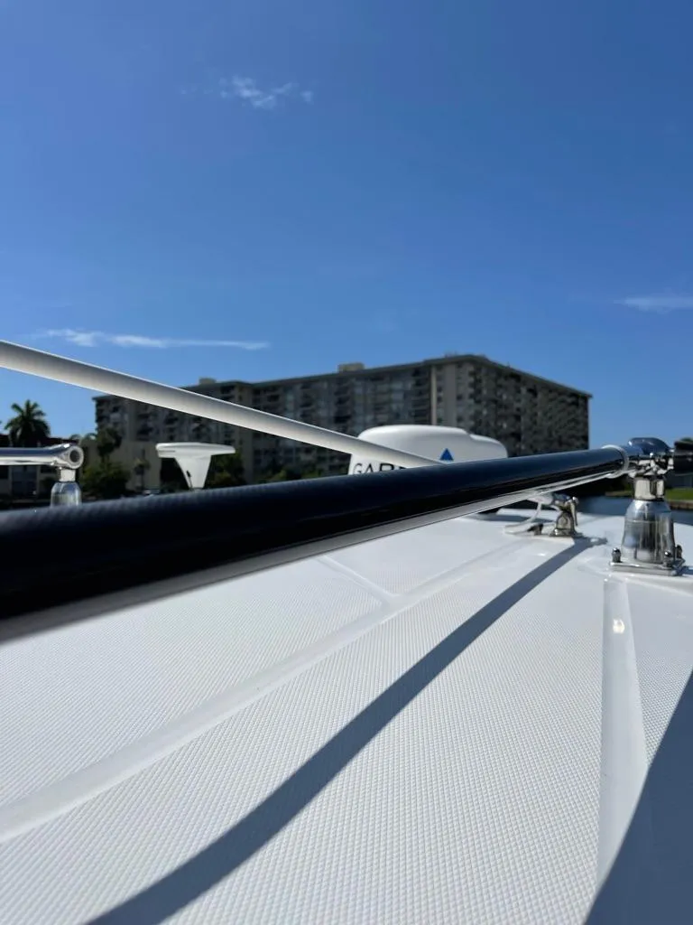 Slide: The Image of 2019 Blackfin 272 CC boat deck with clear blue sky and distant building. - 43