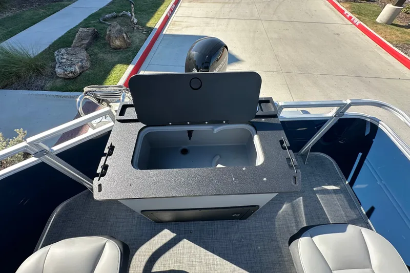 Slide: The Image of 2026 Sun Tracker SportFish 22 XP3 boat interior with open storage compartment. - 23