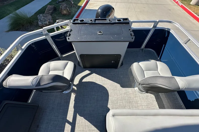 Slide: The Image of 2026 Sun Tracker SportFish 22 XP3 boat interior with seating and control panel. - 22