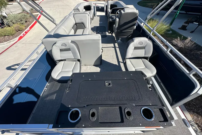 Slide: The Image of 2026 Sun Tracker SportFish 22 XP3 pontoon boat interior with seating and steering console. - 27