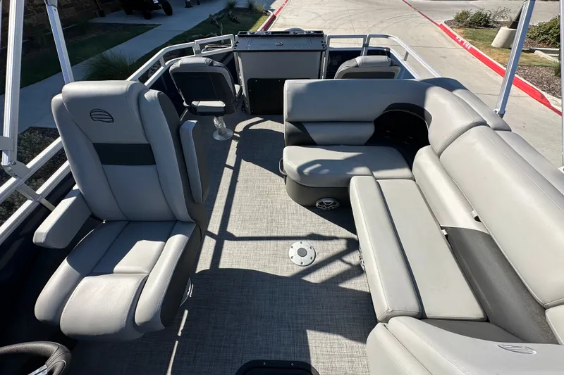 Slide: The Image of 2026 Sun Tracker SportFish 22 XP3 pontoon boat interior with gray seating and spacious layout. - 21