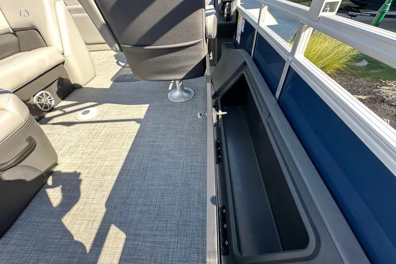 Slide: The Image of Interior of 2026 Sun Tracker SportFish 22 XP3 boat, featuring seating and storage compartment. - 25