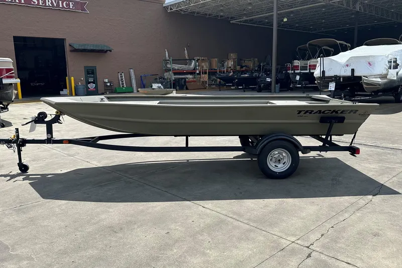 The Image of 2026 Tracker Grizzly 1754 Utility boat on trailer in outdoor service area. - 0