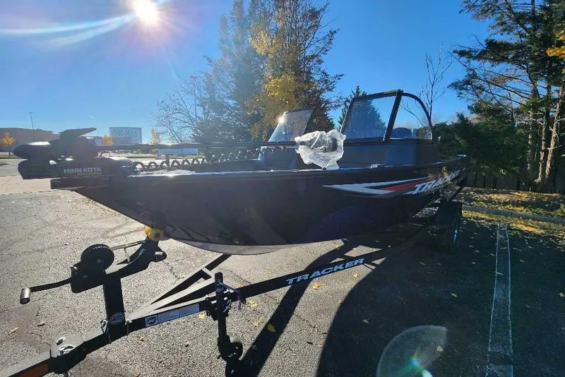 The Image of 2026 Tracker Pro Guide V-16 WT boat on trailer under bright sun. - 0