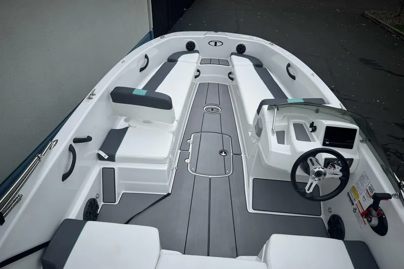Slide: The Image of 2026 Tahoe T18 boat interior with sleek seating, modern dashboard, and spacious layout. - 14