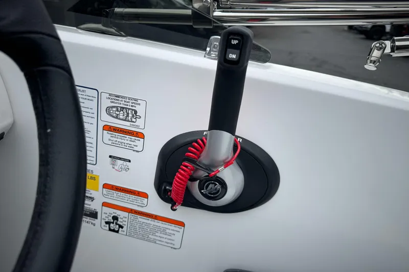 Slide: The Image of Control panel of 2026 Tahoe T18 boat with throttle lever and safety warnings. - 26