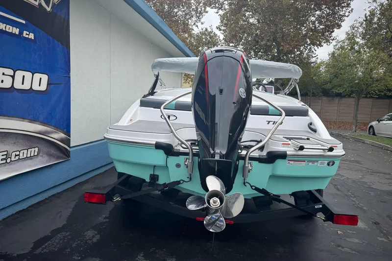 Slide: The Image of 2026 Tahoe T18 boat with outboard motor, parked outdoors near a building. - 4