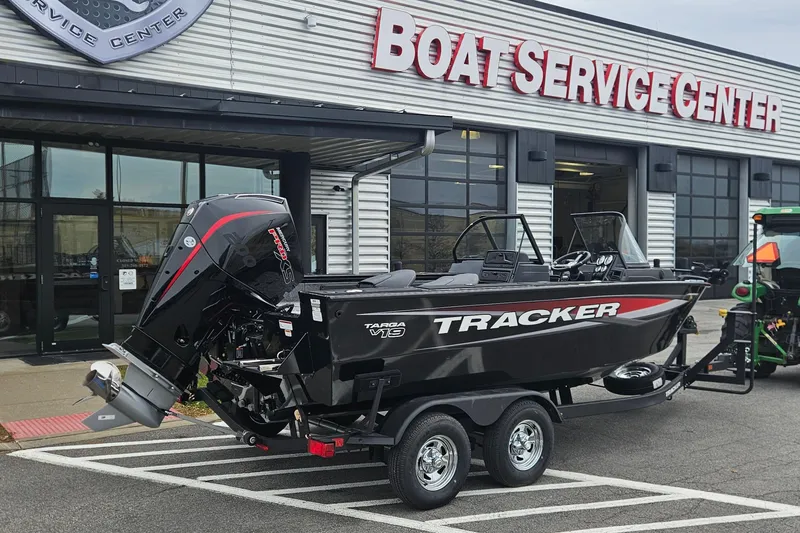 Slide: The Image of 2026 Tracker Targa V-19 Combo boat at service center, on trailer, side view. - 2