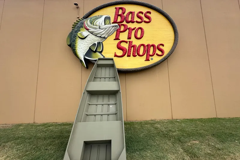 The Image of 2026 Tracker Grizzly 14 Jon boat displayed at Bass Pro Shops entrance. - 0
