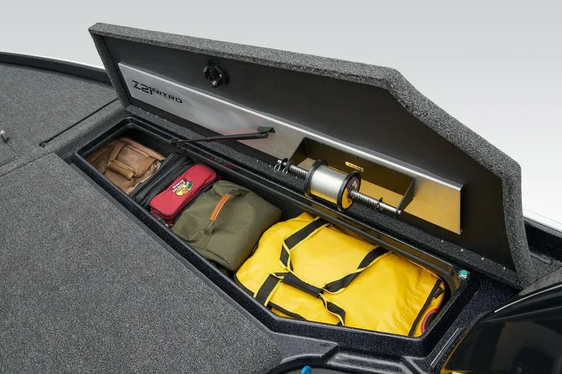 Slide: The Image of Interior storage compartment of 2026 Nitro Z21 XL Pro boat, featuring carpeted lining. - 22