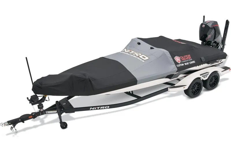 Slide: The Image of 2026 Nitro Z21 XL Pro boat at dealership, rear view with motor and trailer. - 8