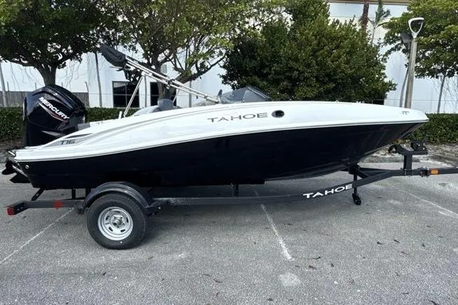 Slide: The Image of 2026 Tahoe T16 boat on trailer, parked outdoors, side view. - 1