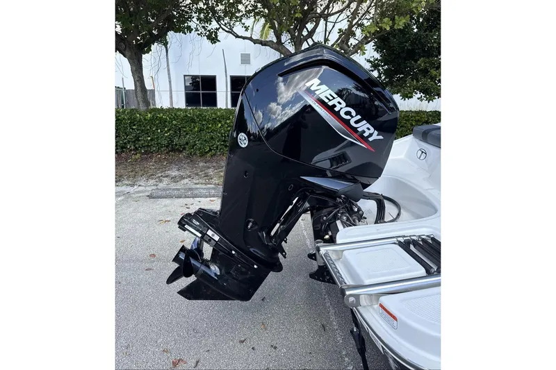 Slide: The Image of 2026 Tahoe T16 boat with Mercury outboard motor in a parking area. - 7