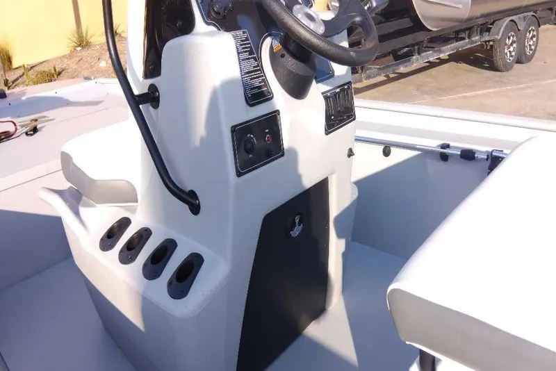 Slide: The Image of 2026 Tracker Bass Tracker Classic CC boat console with steering wheel and seating. - 3