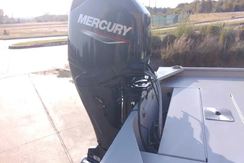 Slide: The Image of 2026 Tracker Bass Tracker Classic CC with Mercury outboard motor in outdoor setting. - 4