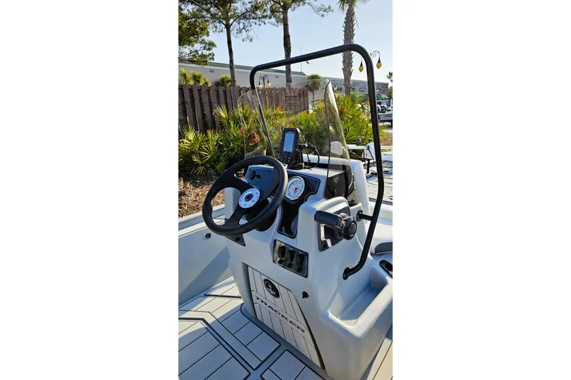 Slide: The Image of 2026 Tracker Bass Tracker Classic CC boat console with steering wheel and gauges. - 10