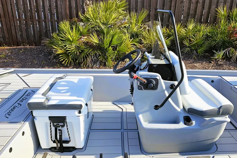 Slide: The Image of 2026 Tracker Bass Tracker Classic CC boat interior with steering console and seating. - 11