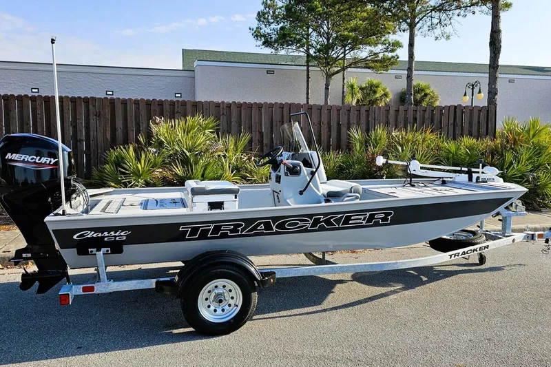 Slide: The Image of 2026 Tracker Bass Tracker Classic CC boat on trailer, parked outdoors. - 2