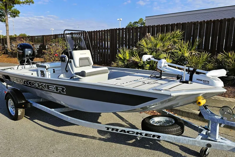 Slide: The Image of 2026 Tracker Bass Tracker Classic CC boat on trailer, featuring Minn Kota motor. - 5