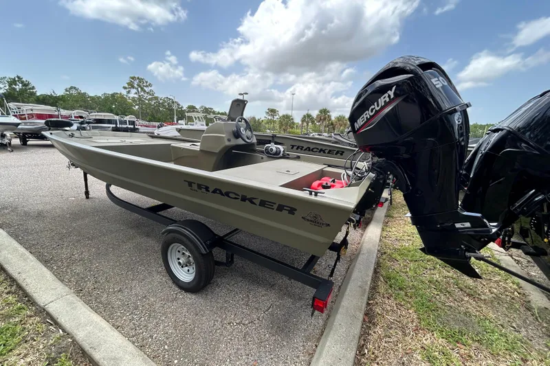 The Image of 2026 Tracker Grizzly 1648 SC boat with Mercury engine on trailer, parked outdoors. - 0