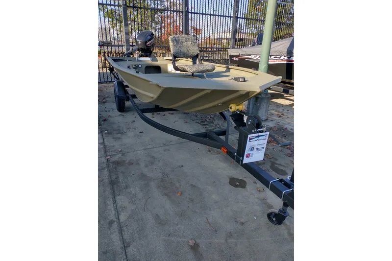 The Image of 2026 Tracker Grizzly 1654 T Sportsman boat on trailer, outdoor display. - 0