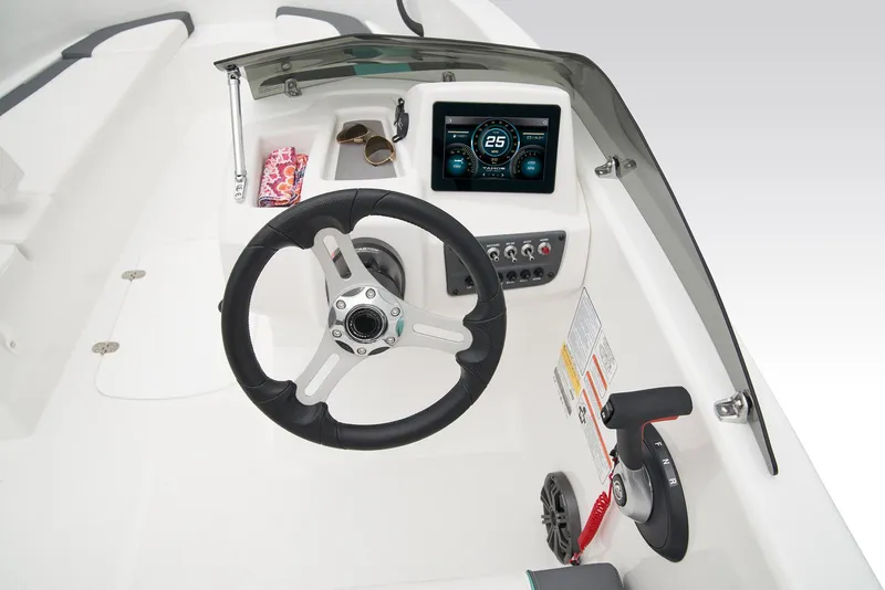 Slide: The Image of 2026 Tahoe T16 boat interior with steering wheel, seating, and control panel. - 13