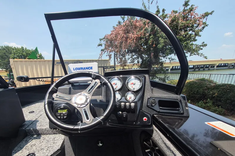 Slide: The Image of 2026 Tracker Targa V-19 WT boat dashboard with steering wheel and gauges. - 88