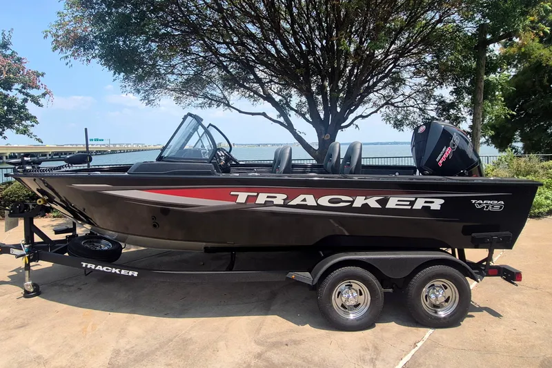 The Image of 2026 Tracker Targa V-19 WT boat on trailer, parked near a scenic waterfront. - 0