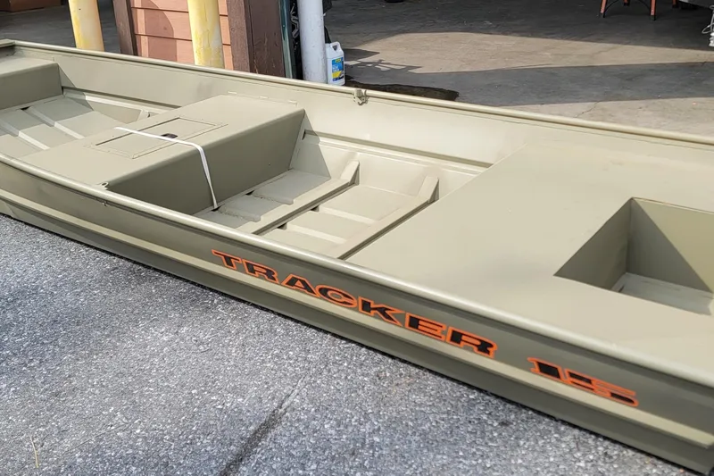 The Image of 2026 Tracker Grizzly 15 Jon boat in a garage setting. - 0