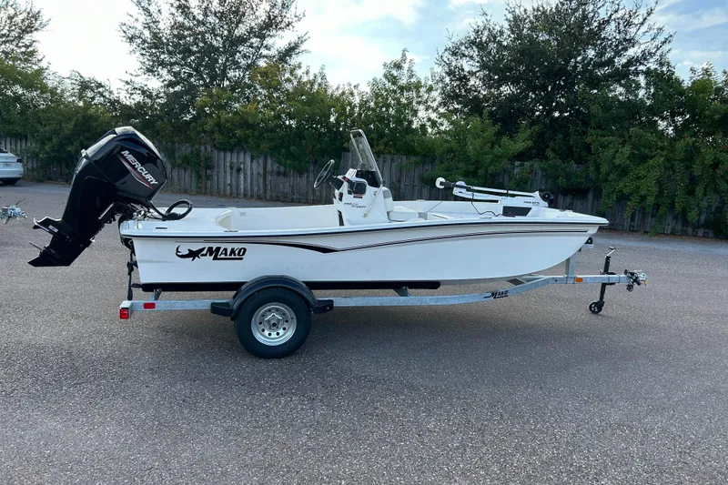 The Image of 2026 Mako Pro Skiff 15 CC boat on trailer, parked outdoors. - 0