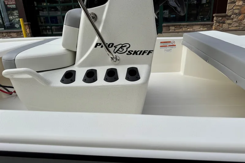 Slide: The Image of 2026 Mako Pro Skiff 13 CC boat interior with seating and rod holders. - 3