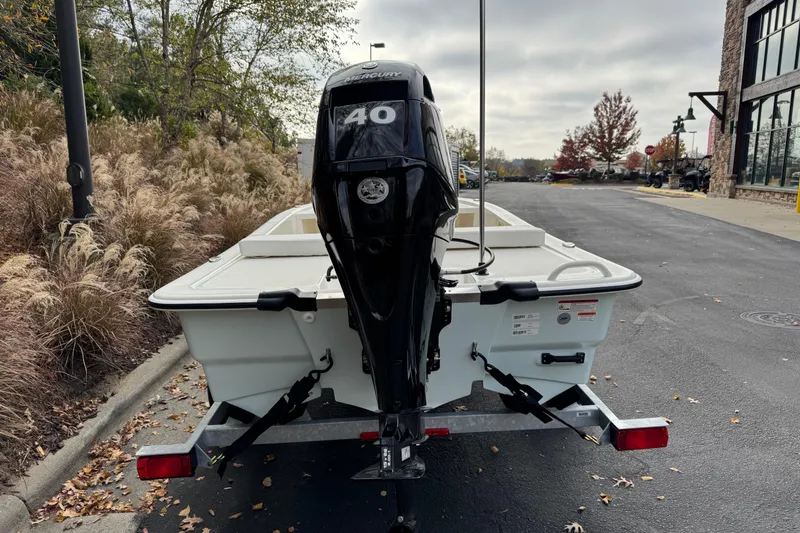 Slide: The Image of 2026 Mako Pro Skiff 13 CC with Mercury 40 engine on trailer, parked outdoors. - 4