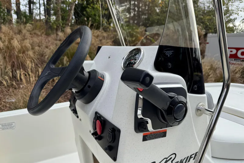 Slide: The Image of Steering console of 2026 Mako Pro Skiff 13 CC boat with throttle and controls. - 5